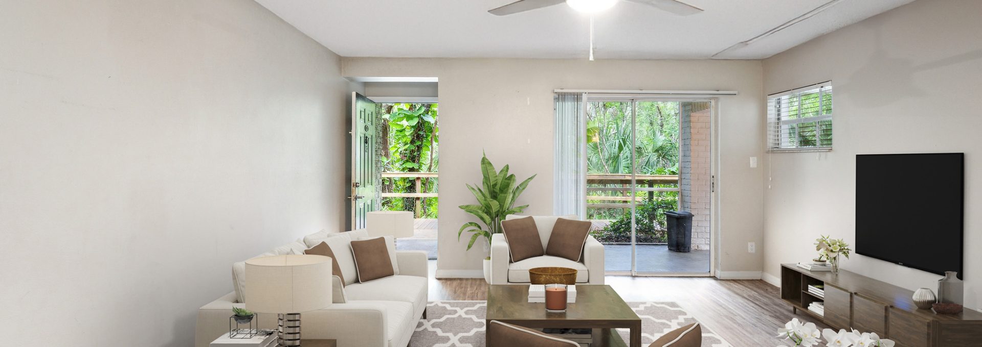 a living room with a ceiling fan and hardwood floors at The  Brady at Tampa Palms